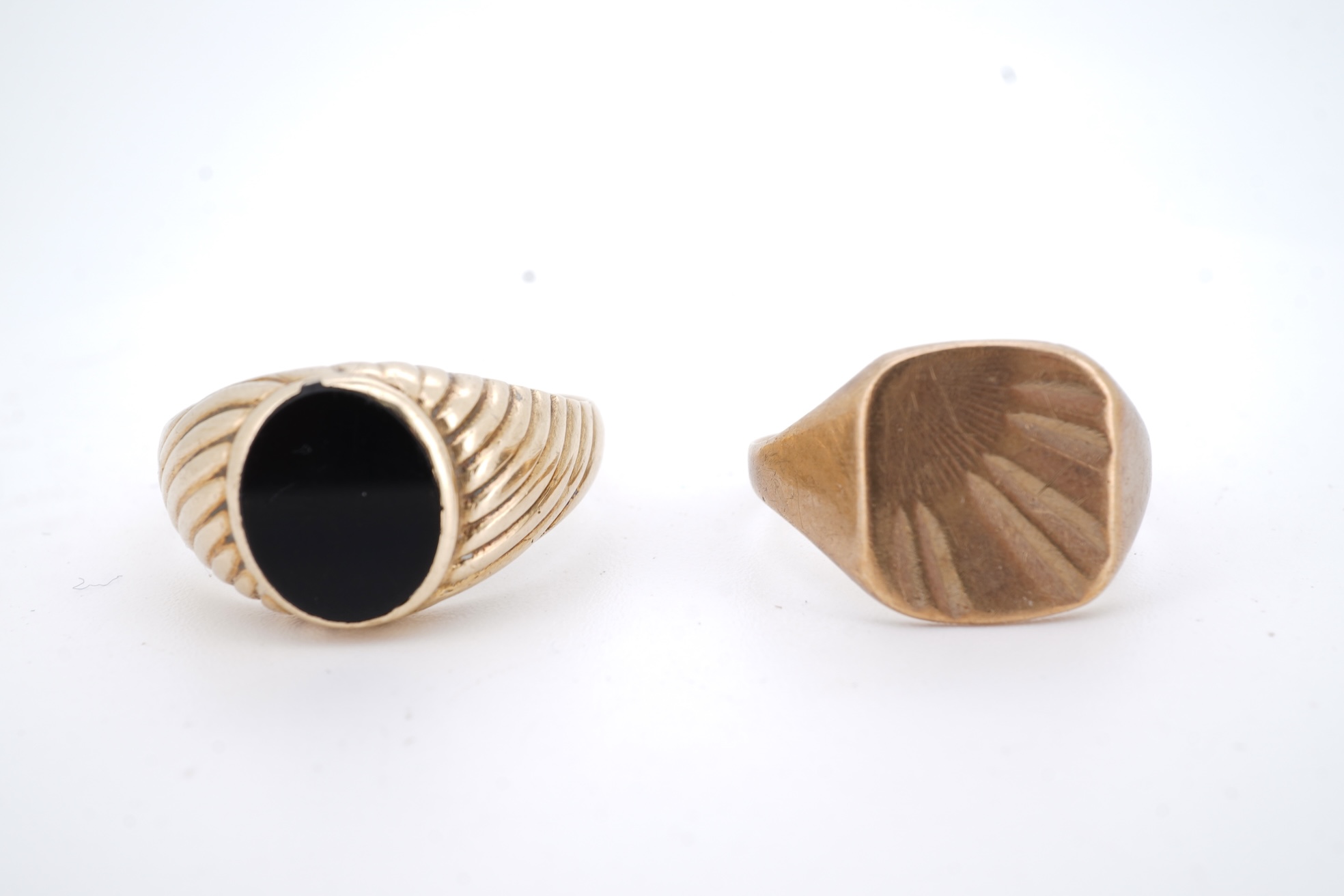 A 1960's 9ct gold and black onyx set signet ring, size X, one other 9ct gold signet ring, a 9ct gold dress stud, a 9ct gold pendant mount and two damaged 9k necklaces, gross weight 21 grams.